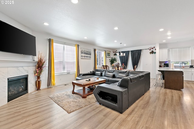2504 Brackenfern Rd, Eugene, OR 97403 - living room featuring light wood-type flooring, recessed lighting, a premium fireplace, and baseboards
