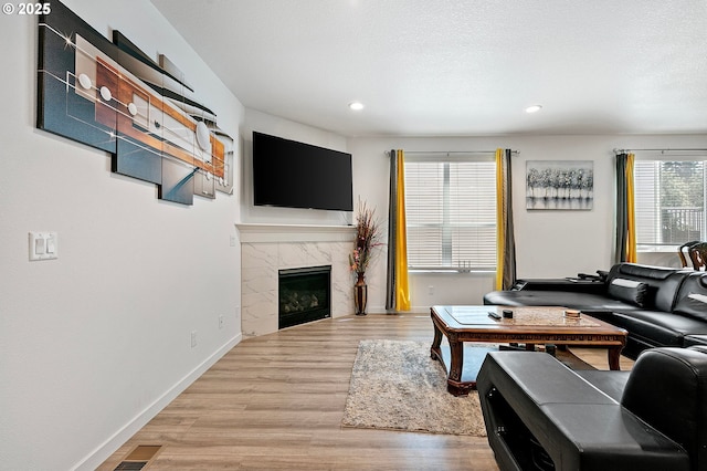 2504 Brackenfern Rd, Eugene, OR 97403 - living area with wood finished floors, recessed lighting, a high end fireplace, and baseboards