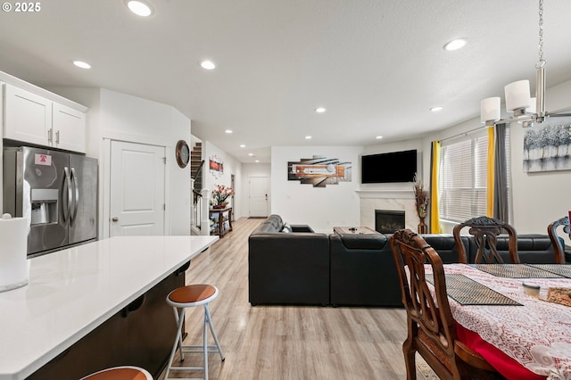2504 Brackenfern Rd, Eugene, OR 97403 - dining area with light wood-style flooring, recessed lighting, and a premium fireplace