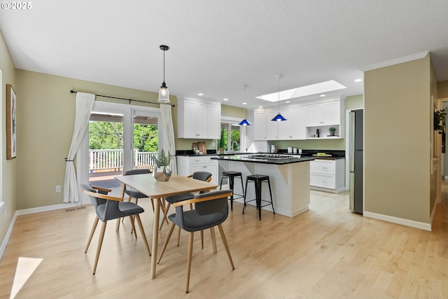 6025 SW Spruce Ave, Beaverton, OR 97005 - dining room featuring a skylight, light wood-style floors, baseboards, and recessed lighting