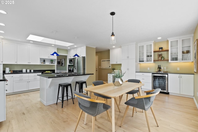 6025 SW Spruce Ave, Beaverton, OR 97005 - dining area with wine cooler, recessed lighting, light wood-type flooring, and a bar