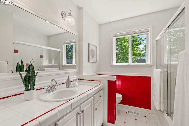 6025 SW Spruce Ave, Beaverton, OR 97005 - full bath featuring vanity, toilet, an enclosed shower, and tile patterned flooring