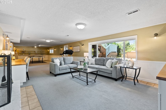 6025 SW Spruce Ave, Beaverton, OR 97005 - carpeted living area with tile patterned flooring, wainscoting, and a textured ceiling