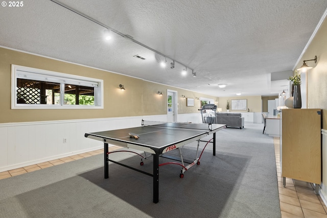 6025 SW Spruce Ave, Beaverton, OR 97005 - recreation room featuring a textured ceiling, rail lighting, light tile patterned flooring, and wainscoting