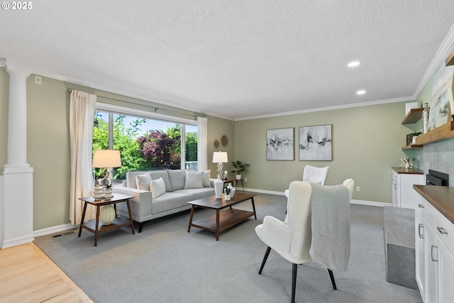 6025 SW Spruce Ave, Beaverton, OR 97005 - living area with a textured ceiling, crown molding, decorative columns, baseboards, and recessed lighting