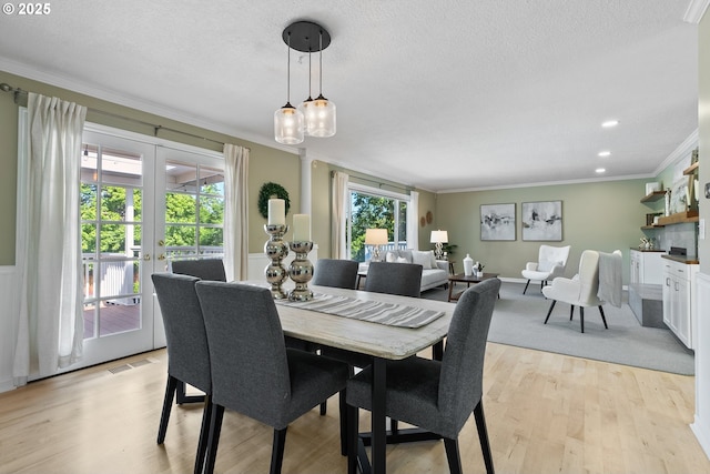 6025 SW Spruce Ave, Beaverton, OR 97005 - dining room featuring crown molding, french doors, light wood-type flooring, and a textured ceiling