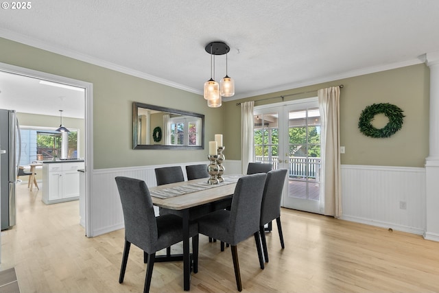 6025 SW Spruce Ave, Beaverton, OR 97005 - dining area featuring light wood-type flooring, a wainscoted wall, ornamental molding, decorative columns, and a textured ceiling