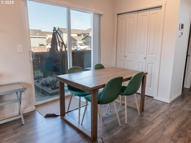 dining room with dark hardwood / wood-style flooring