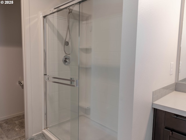 bathroom featuring vanity and a shower with door