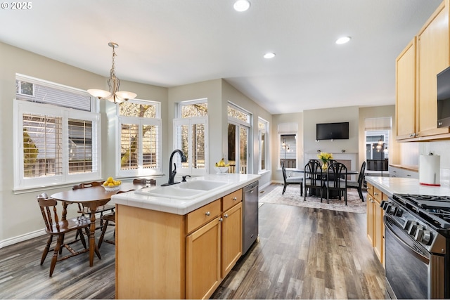 kitchen featuring dark wood-style floors, range with gas cooktop, a sink, and stainless steel dishwasher