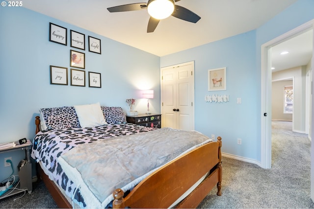 carpeted bedroom featuring a ceiling fan and baseboards