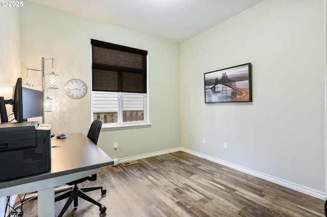 home office featuring visible vents, baseboards, and wood finished floors