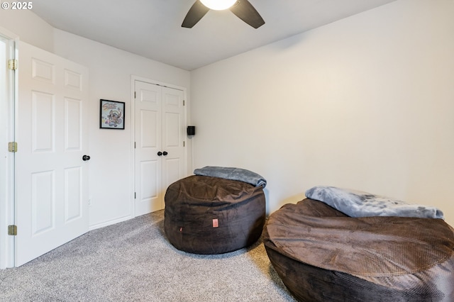 sitting room featuring carpet flooring and a ceiling fan