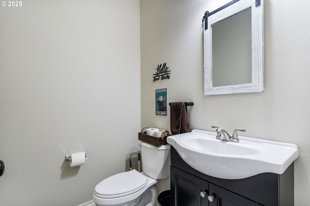 half bathroom with vanity and toilet