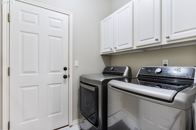 clothes washing area with cabinet space and independent washer and dryer