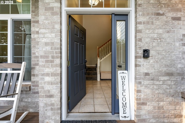 view of exterior entry featuring brick siding