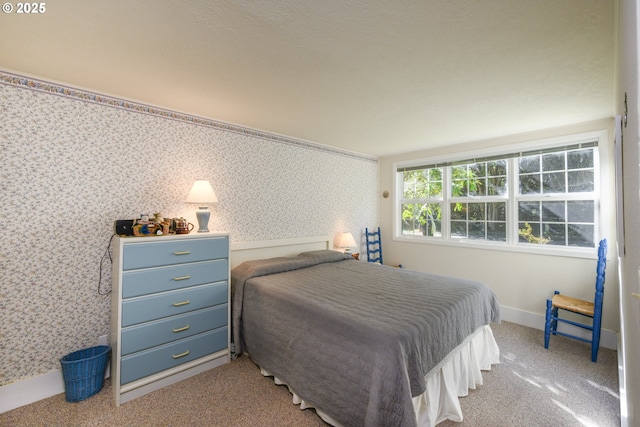 bedroom with baseboards, carpet, and wallpapered walls