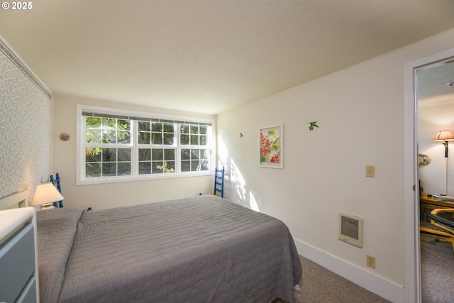 carpeted bedroom featuring baseboards