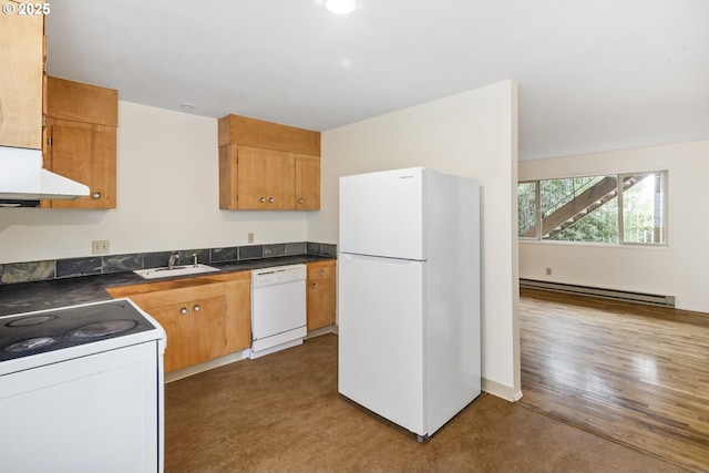 kitchen featuring dark countertops, extractor fan, baseboard heating, white appliances, and a sink