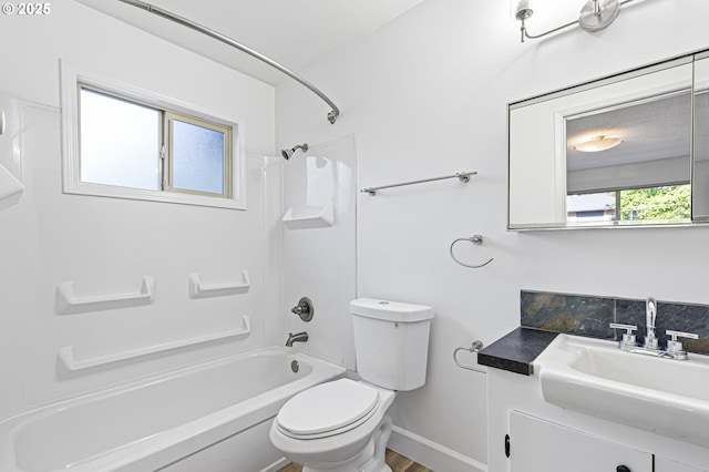 full bathroom featuring toilet, vanity, baseboards, and washtub / shower combination