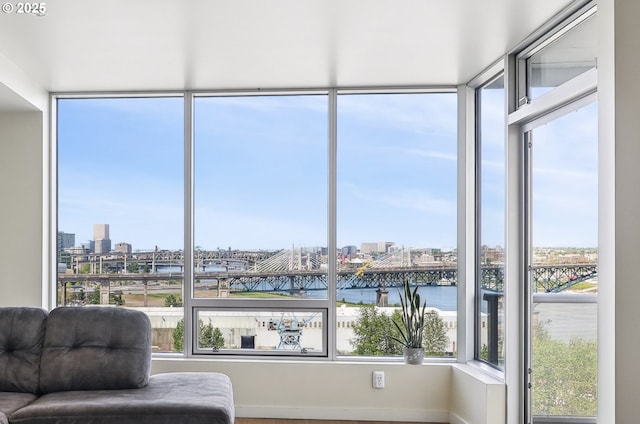 sunroom / solarium with a view of city and a water view