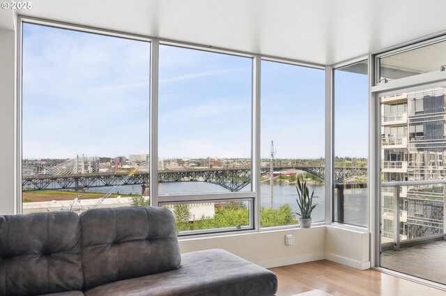 sunroom / solarium with a view of city and a water view