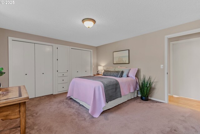 carpeted bedroom with two closets