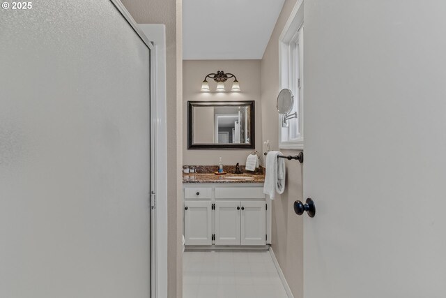 bathroom featuring baseboards, vanity, and tile patterned floors