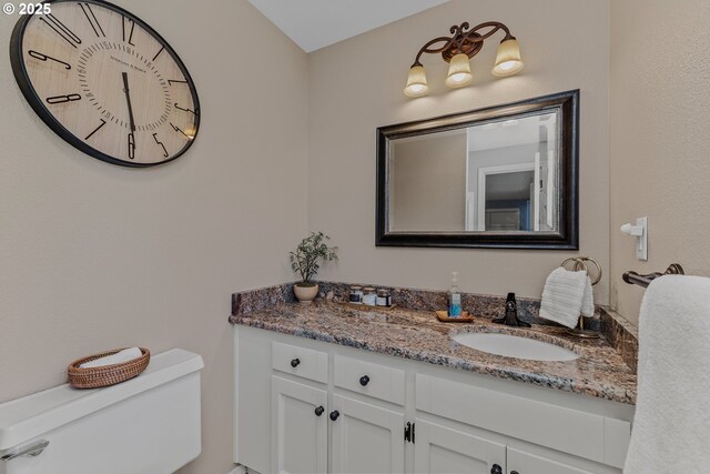 bathroom with toilet and vanity