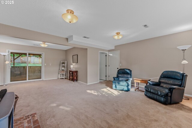 living area featuring carpet flooring and baseboards
