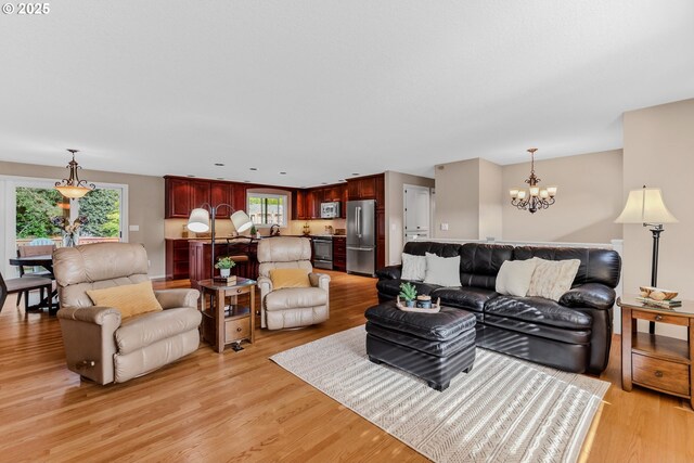 living area with a chandelier and light wood-style floors