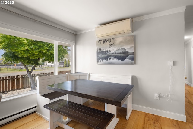 dining room with baseboard heating, light wood-style floors, ornamental molding, and a wall mounted AC