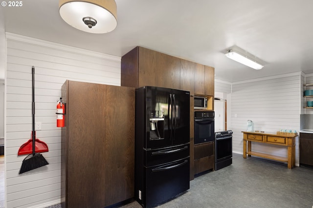 kitchen featuring a warming drawer, wood walls, ornamental molding, and black appliances