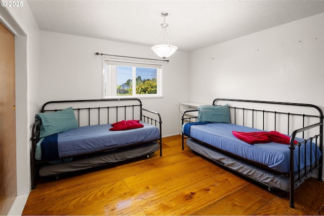 bedroom with hardwood / wood-style flooring