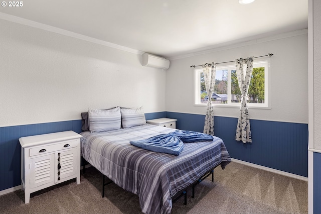 carpeted bedroom with crown molding, an AC wall unit, and wainscoting