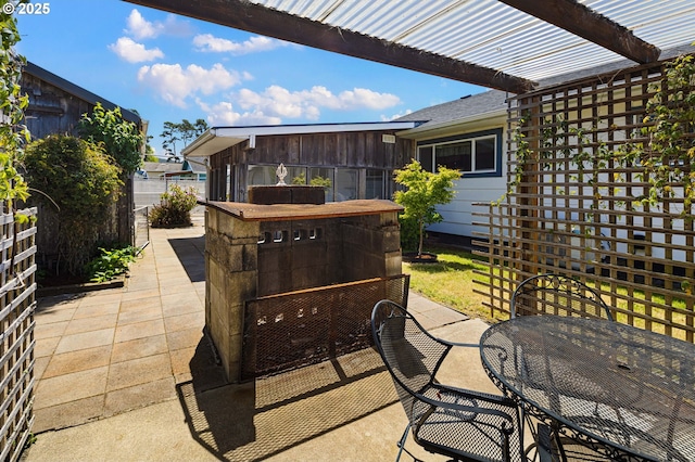 view of patio with fence and outdoor dining area
