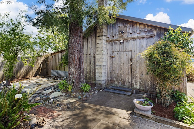view of outbuilding with fence