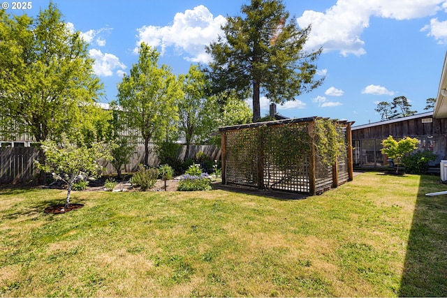 view of yard with a fenced backyard, exterior structure, and an outdoor structure