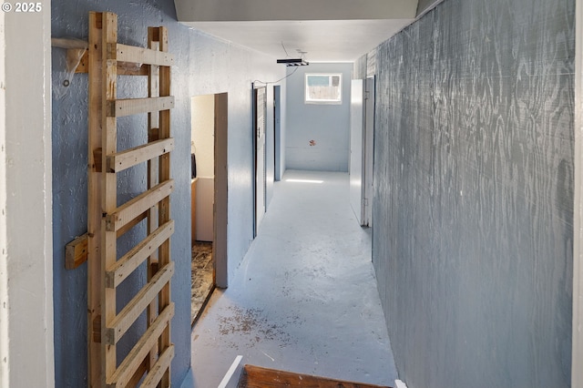 hall with concrete flooring