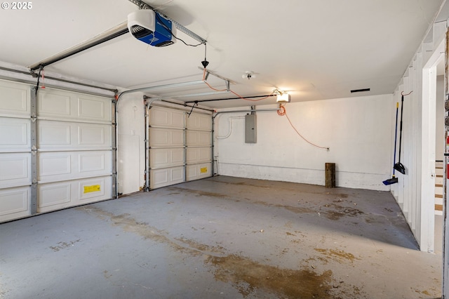 garage featuring a garage door opener and electric panel