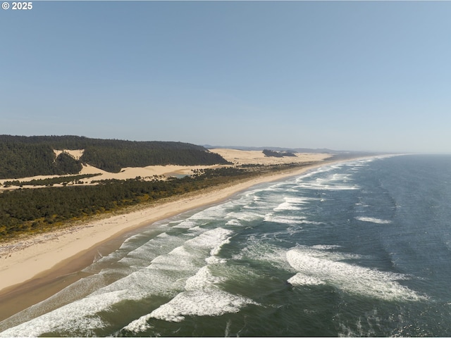 view of road with a water view and a view of the beach