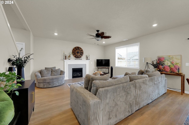 living room featuring ceiling fan and light wood-type flooring