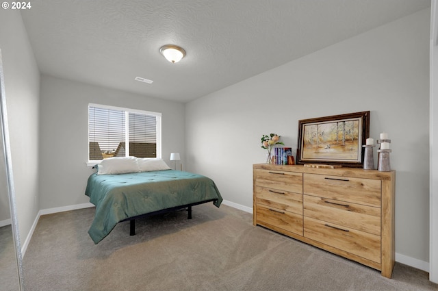 carpeted bedroom with a textured ceiling