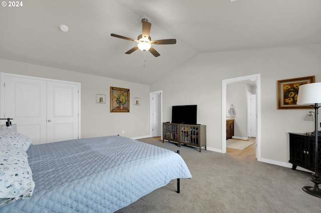 bedroom featuring lofted ceiling, a closet, ceiling fan, and carpet