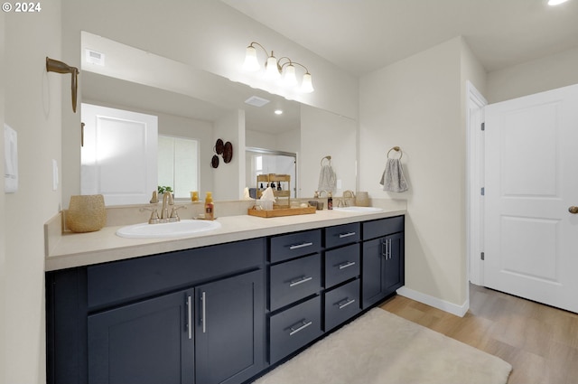 bathroom with vanity and hardwood / wood-style flooring