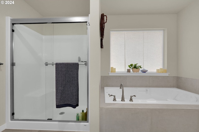 bathroom featuring separate shower and tub