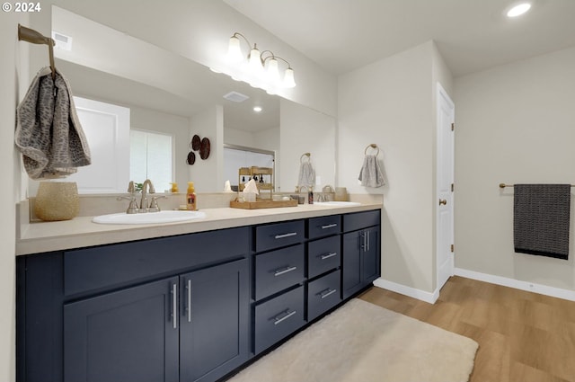 bathroom with vanity and hardwood / wood-style flooring