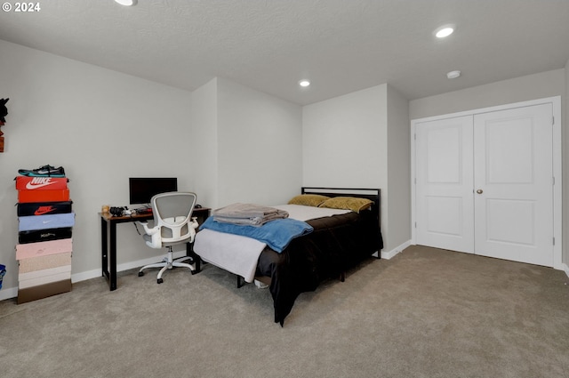 bedroom featuring carpet flooring and a textured ceiling