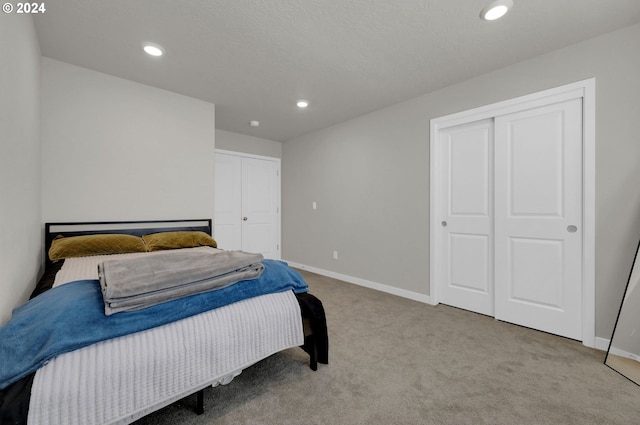 carpeted bedroom featuring two closets