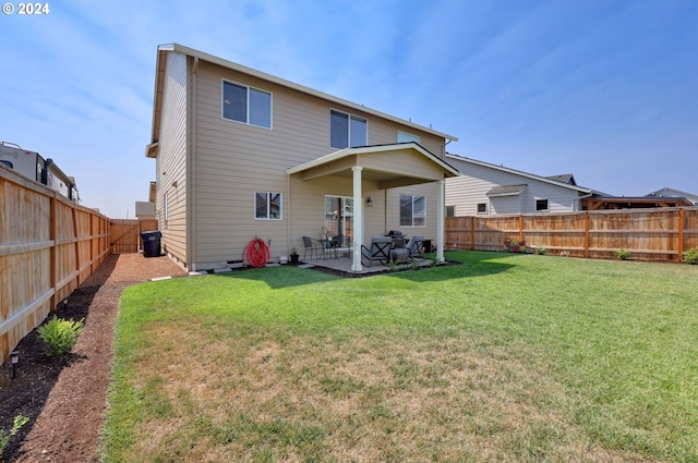 rear view of property featuring a patio area and a lawn